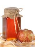    honey in a jar with red apple